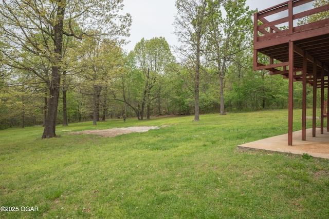 view of yard with a wooden deck and a patio
