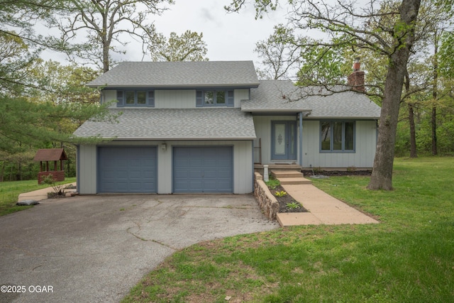 split level home with driveway, a chimney, roof with shingles, a garage, and a front lawn