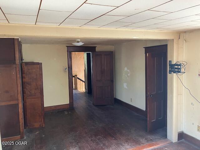 spare room with wood finished floors and baseboards
