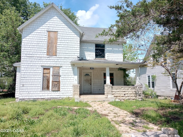 view of front of property with a porch and a shingled roof