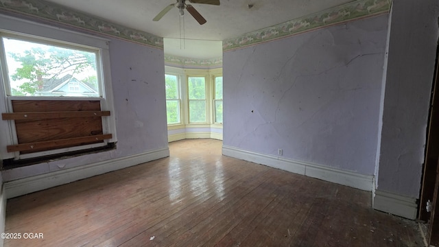 114 S Pennsylvania St, Webb City, MO 64870 - unfurnished living room with a ceiling fan, baseboards, and wood-type flooring