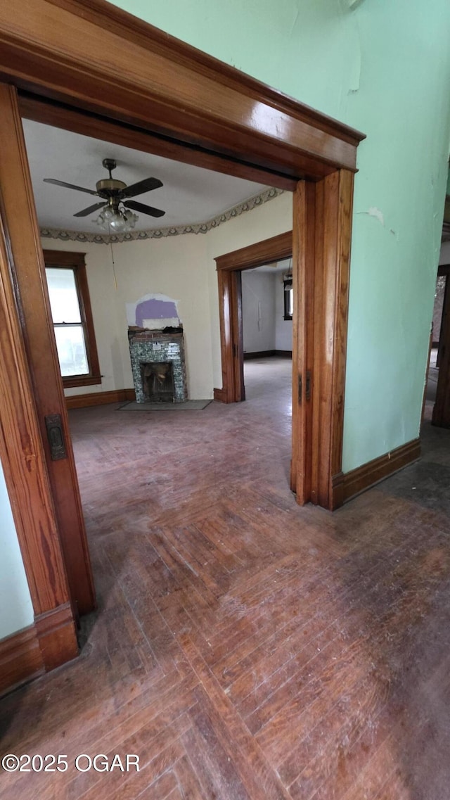 114 S Pennsylvania St, Webb City, MO 64870 - unfurnished living room with a fireplace, ceiling fan, and baseboards