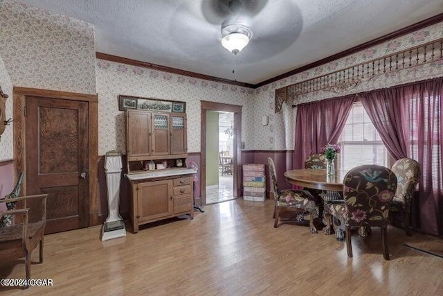 1418 Cleveland Ave, Baxter Springs, KS 66713 - dining area with wallpapered walls, wainscoting, a ceiling fan, ornamental molding, and healthy amount of natural light