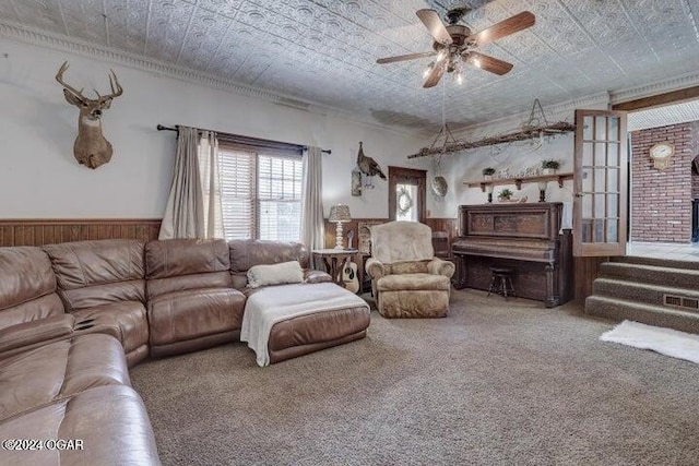 1418 Cleveland Ave, Baxter Springs, KS 66713 - carpeted living room with ceiling fan, wainscoting, ornamental molding, and wooden walls