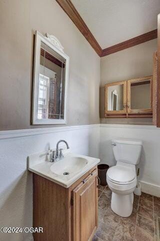 1418 Cleveland Ave, Baxter Springs, KS 66713 - half bathroom with crown molding, toilet, vanity, and a wainscoted wall