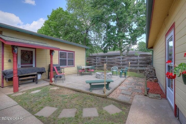 1418 Cleveland Ave, Baxter Springs, KS 66713 - view of patio with fence and an outdoor fire pit
