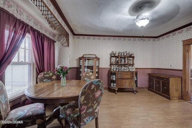 1418 Cleveland Ave, Baxter Springs, KS 66713 - dining room with a wainscoted wall, wallpapered walls, crown molding, and light wood-style floors