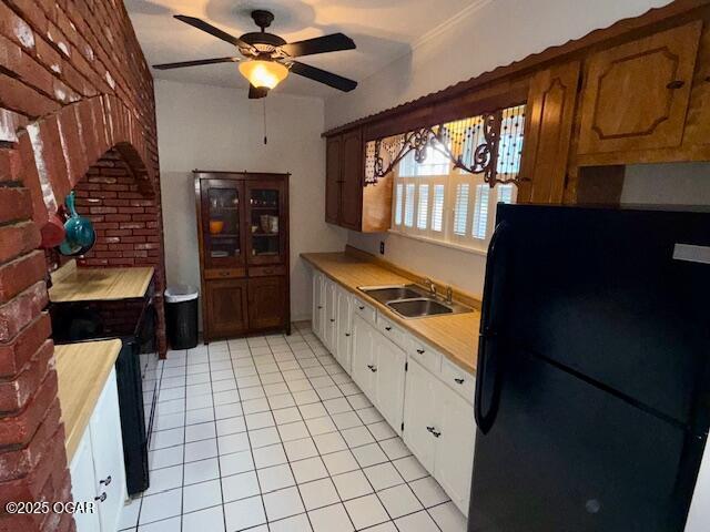1418 Cleveland Ave, Baxter Springs, KS 66713 - kitchen featuring black appliances, a sink, light countertops, a ceiling fan, and light tile patterned floors