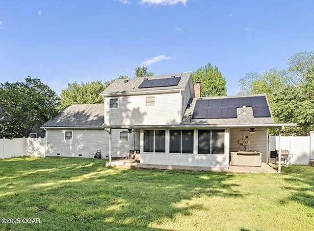 3724 Hawthorn Dr, Joplin, MO 64804 - back of house featuring roof mounted solar panels, a sunroom, a patio, and a lawn