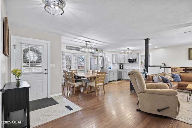 400 Silverwood Ln, Joplin, MO 64801 - living room with wood-type flooring, a textured ceiling, and baseboards