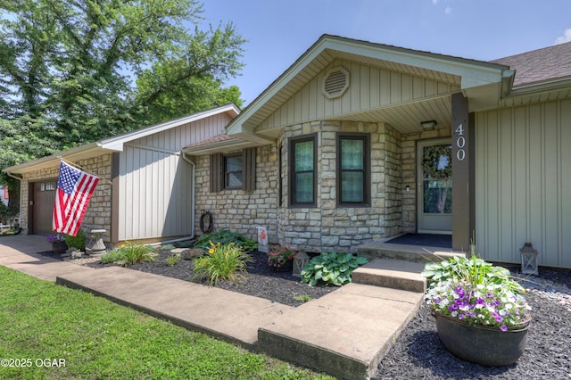 400 Silverwood Ln, Joplin, MO 64801 - entrance to property with a garage, stone siding, board and batten siding, and roof with shingles