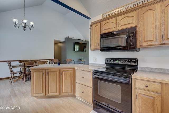 4537 Dolphin Dr, Joplin, MO 64804 - kitchen featuring a notable chandelier, a peninsula, black appliances, light countertops, and light wood-type flooring