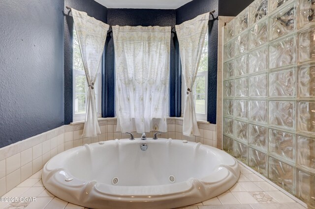 4537 Dolphin Dr, Joplin, MO 64804 - full bath featuring tile patterned floors, a jetted tub, and a textured wall