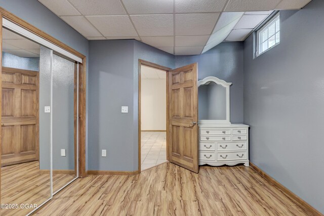 4537 Dolphin Dr, Joplin, MO 64804 - unfurnished bedroom featuring a drop ceiling, baseboards, and wood finished floors