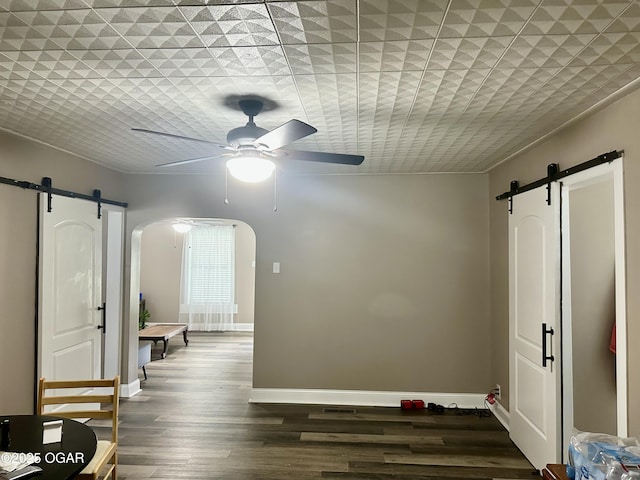 212 N Jefferson St, Webb City, MO 64870 - hallway with a barn door, arched walkways, and baseboards