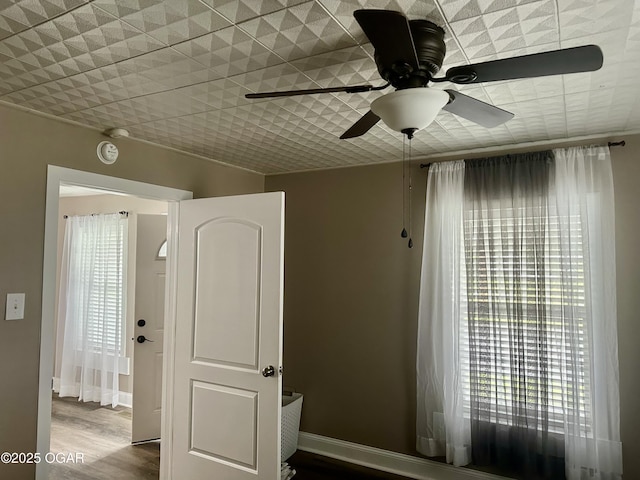 212 N Jefferson St, Webb City, MO 64870 - unfurnished room with wood finished floors, a ceiling fan, and baseboards