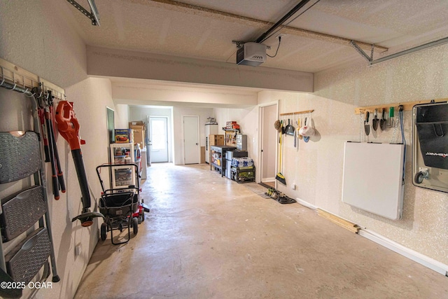 garage with baseboards and a garage door opener
