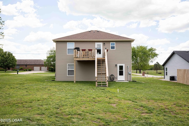 rear view of property with central AC, a yard, stairway, and a deck