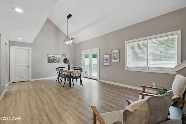 1214 Bramar Dr, Joplin, MO 64804 - dining room with french doors, baseboards, light wood-type flooring, and high vaulted ceiling