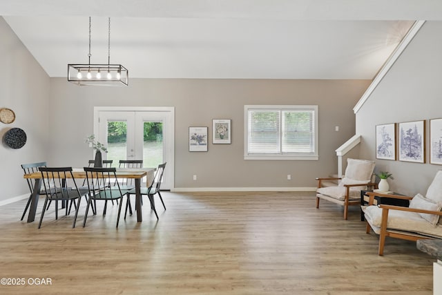 1214 Bramar Dr, Joplin, MO 64804 - dining space with french doors, light wood finished floors, lofted ceiling, and baseboards