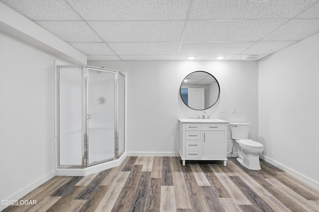 1214 Bramar Dr, Joplin, MO 64804 - bathroom featuring a paneled ceiling, a stall shower, toilet, vanity, and wood finished floors