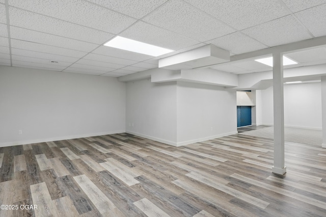 1214 Bramar Dr, Joplin, MO 64804 - finished below grade area with wood finished floors, a paneled ceiling, and baseboards