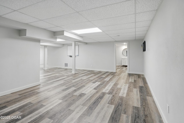 1214 Bramar Dr, Joplin, MO 64804 - finished basement featuring wood finished floors, a drop ceiling, and baseboards