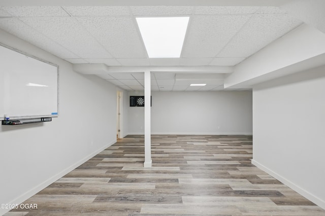 1214 Bramar Dr, Joplin, MO 64804 - finished basement featuring a drop ceiling, wood finished floors, and baseboards