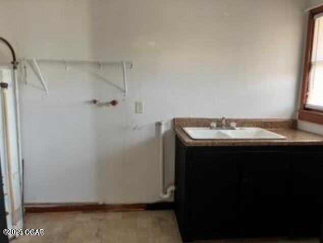 washroom featuring a sink and radiator heating unit