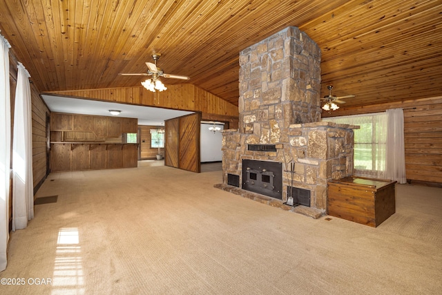 6309 Impala Dr, Joplin, MO 64804 - unfurnished living room featuring wood walls, ceiling fan, plenty of natural light, light carpet, and wooden ceiling