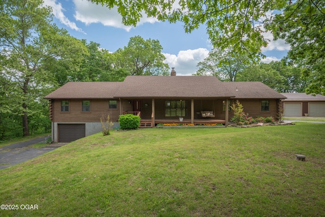 6309 Impala Dr, Joplin, MO 64804 - ranch-style house featuring log exterior, a chimney, a front yard, driveway, and covered porch