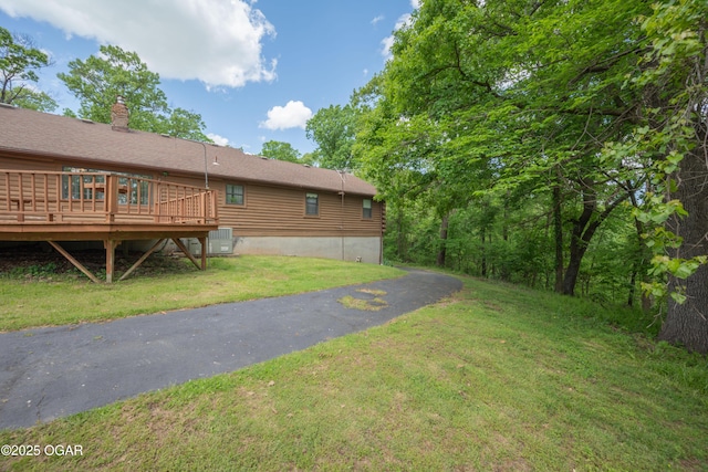6309 Impala Dr, Joplin, MO 64804 - view of grassy yard with a wooden deck and central AC
