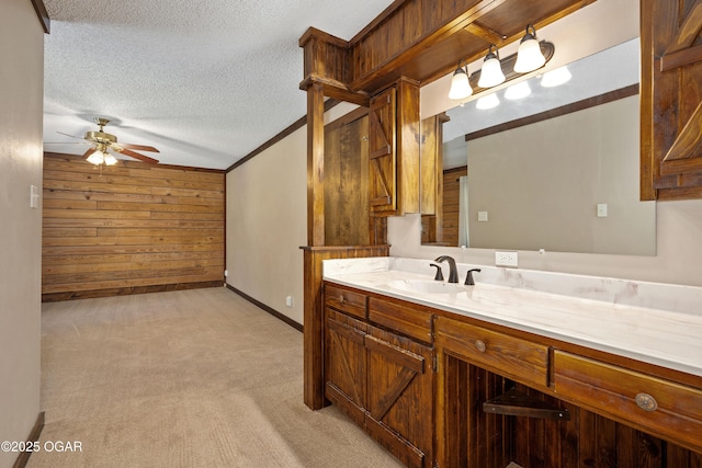 6309 Impala Dr, Joplin, MO 64804 - bathroom featuring a ceiling fan, a textured ceiling, baseboards, vanity, and wooden walls