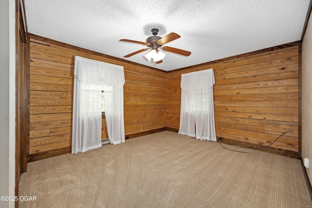 6309 Impala Dr, Joplin, MO 64804 - unfurnished bedroom featuring wooden walls, carpet, a textured ceiling, and ceiling fan