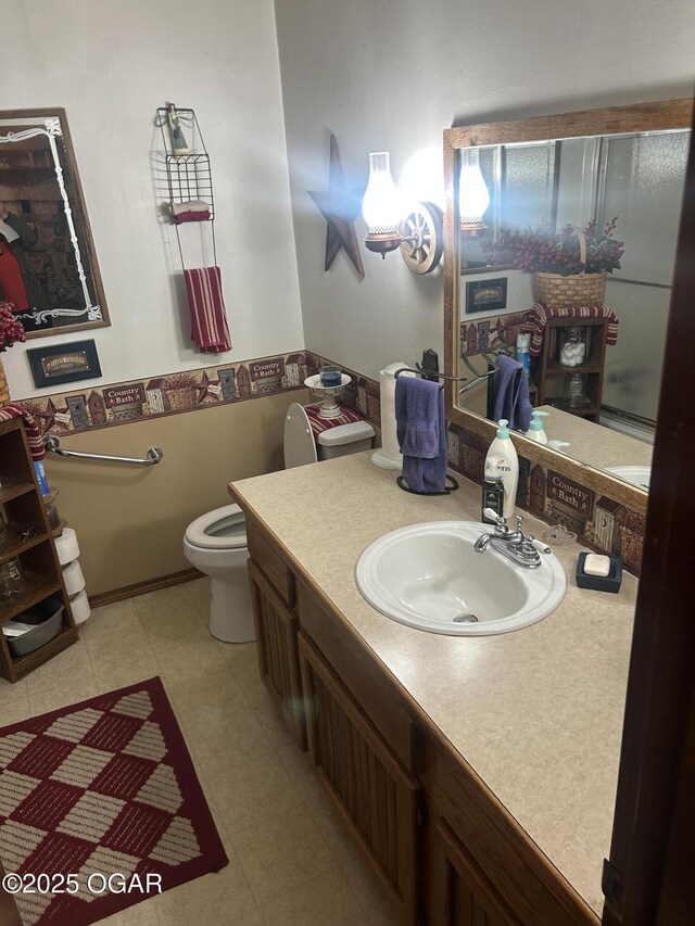bathroom featuring toilet and vanity