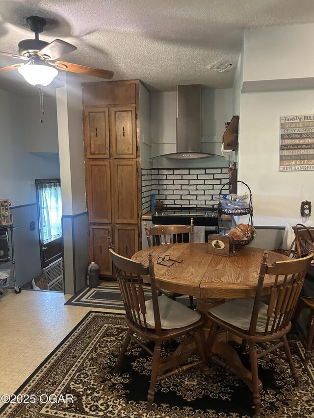 dining space with ceiling fan and a textured ceiling