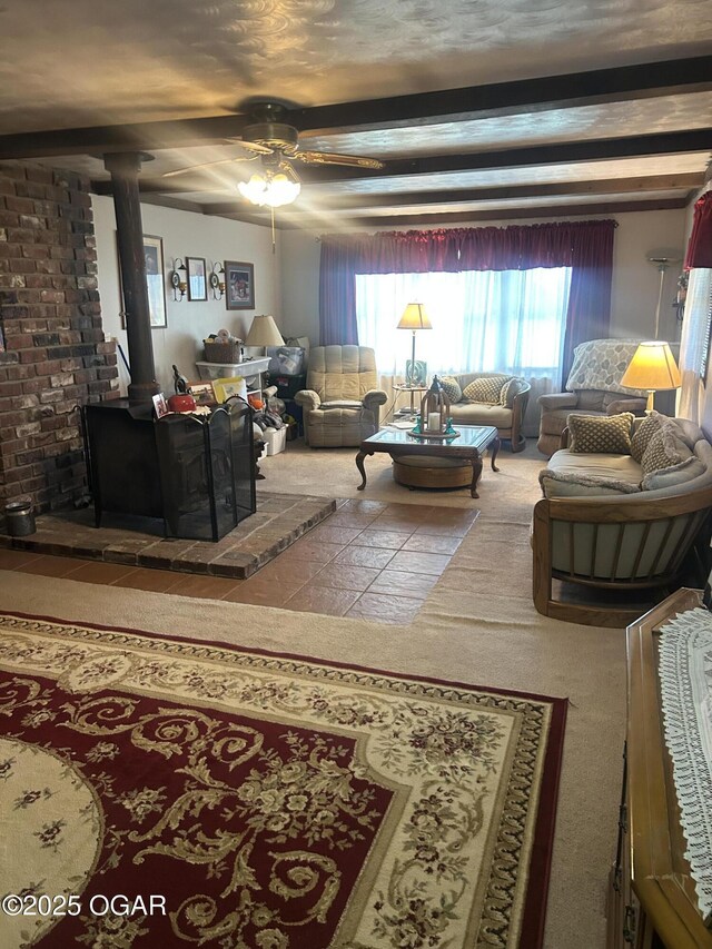 living area with ceiling fan and beam ceiling
