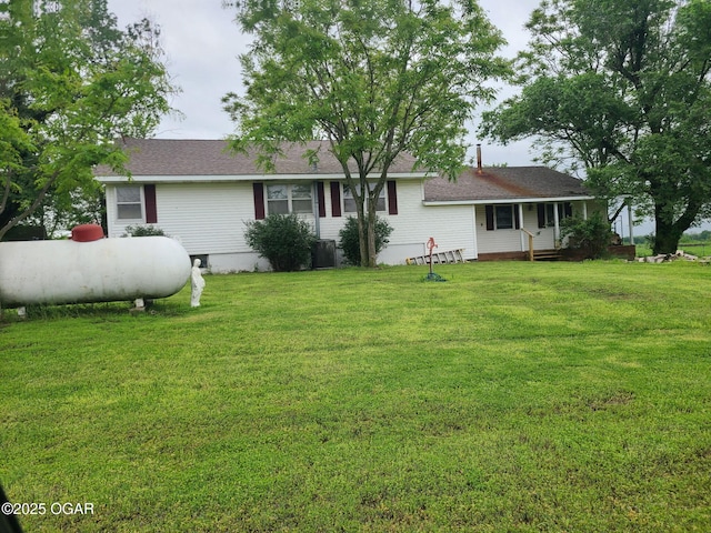 rear view of house with a yard