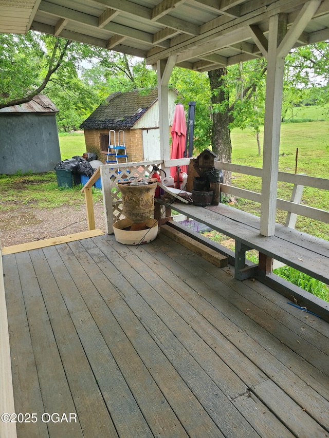 wooden deck with a storage unit and an outdoor structure