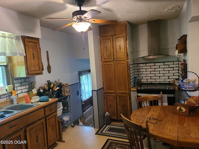 kitchen featuring exhaust hood, brown cabinetry, ceiling fan, electric stove, and light floors