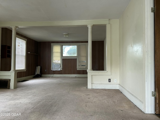 915 W 8th St, Joplin, MO 64801 - unfurnished living room featuring carpet floors, decorative columns, baseboards, and cooling unit