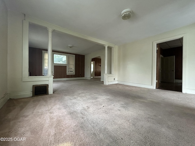 915 W 8th St, Joplin, MO 64801 - unfurnished living room featuring arched walkways, carpet floors, and baseboards