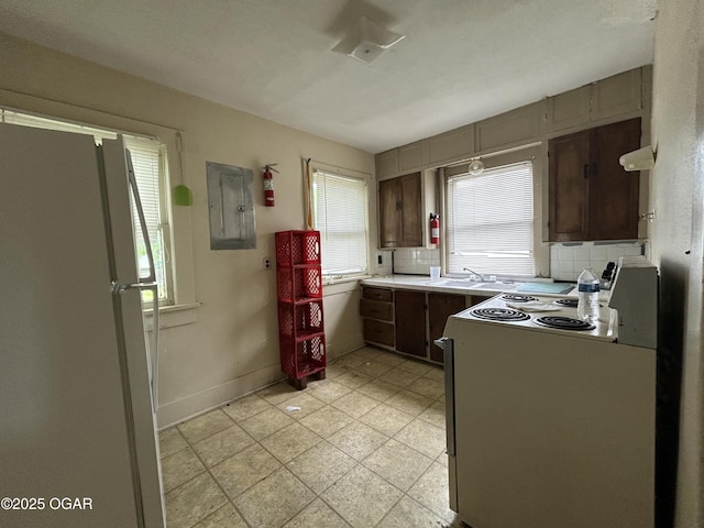 915 W 8th St, Joplin, MO 64801 - kitchen featuring white appliances, electric panel, plenty of natural light, and light countertops