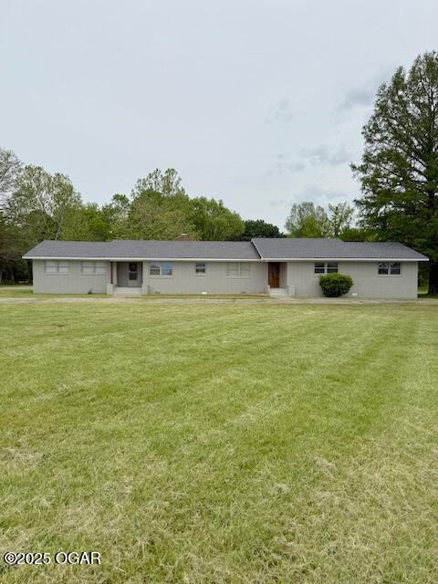 back of house featuring a yard