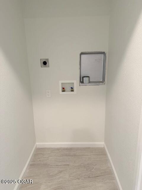 clothes washing area featuring baseboards, laundry area, washer hookup, and electric dryer hookup