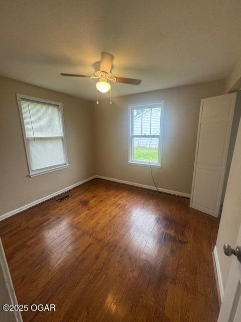 407 Porter, Joplin, MO 64801 - spare room featuring wood finished floors, baseboards, and a ceiling fan
