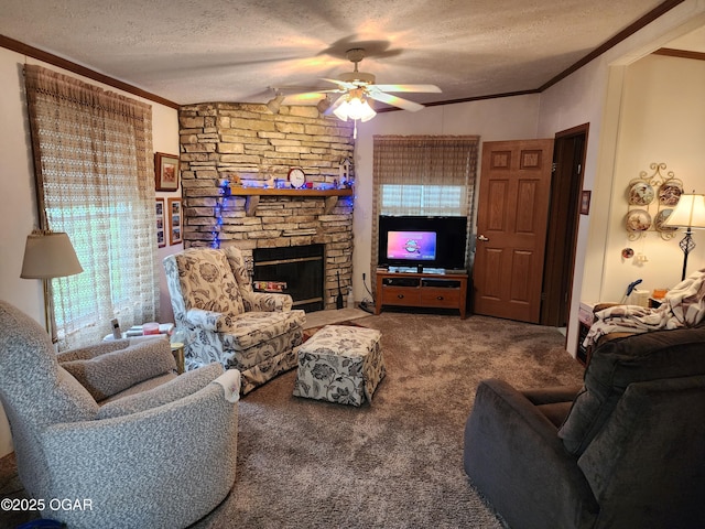 carpeted living room with a textured ceiling, a ceiling fan, ornamental molding, and a stone fireplace