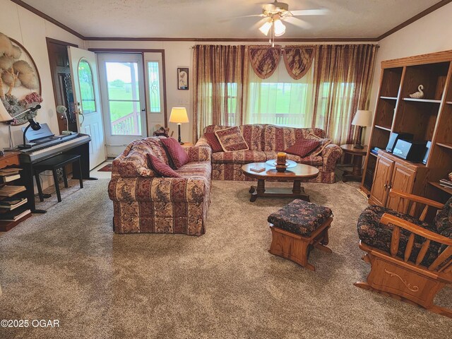 living area with crown molding, plenty of natural light, carpet, a ceiling fan, and a textured ceiling