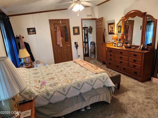 carpeted bedroom featuring ornamental molding and a ceiling fan