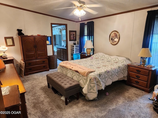 bedroom featuring carpet flooring, ornamental molding, a textured ceiling, a ceiling fan, and ensuite bathroom
